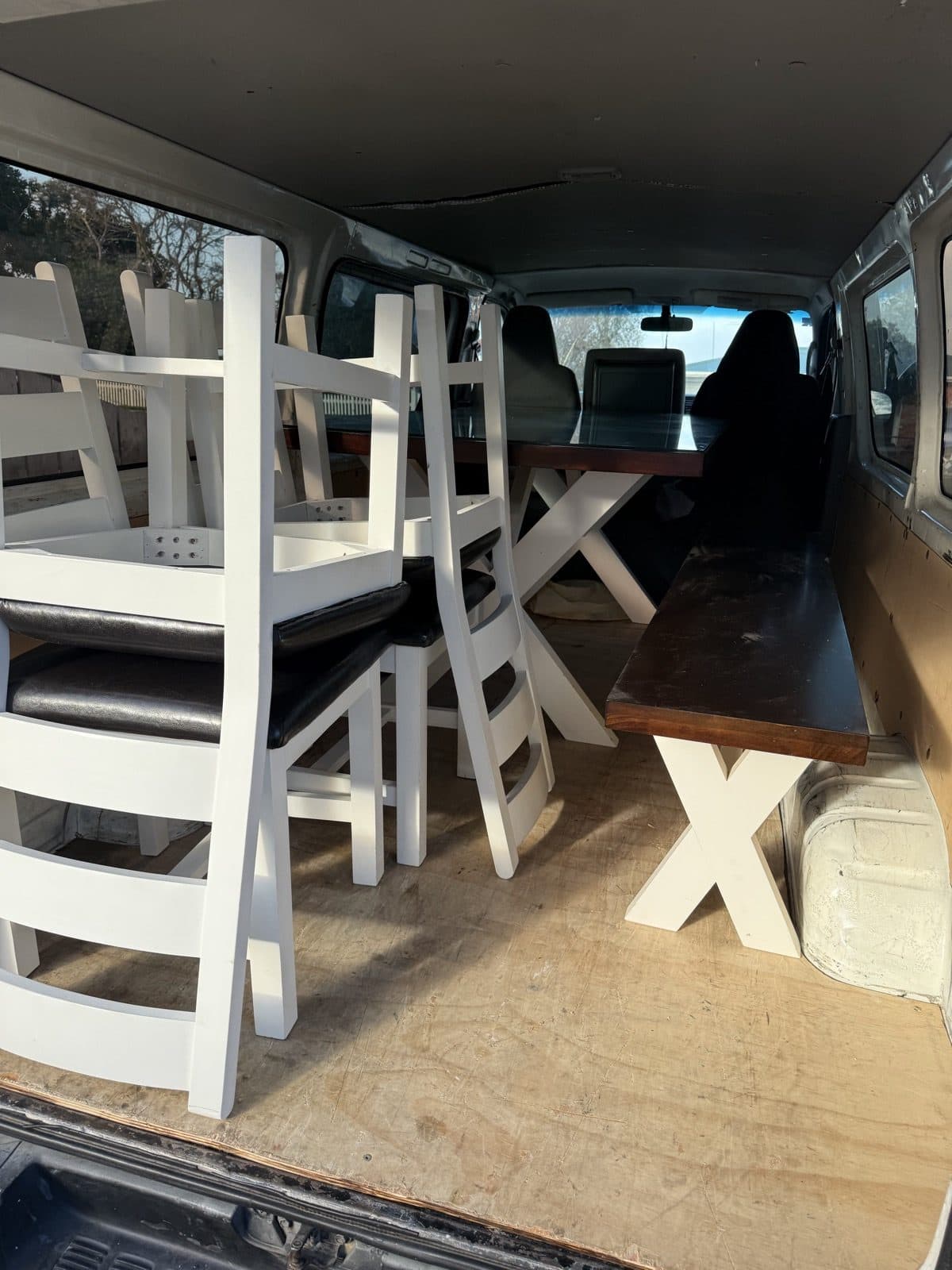 Dining table, chairs and bench loaded with care
