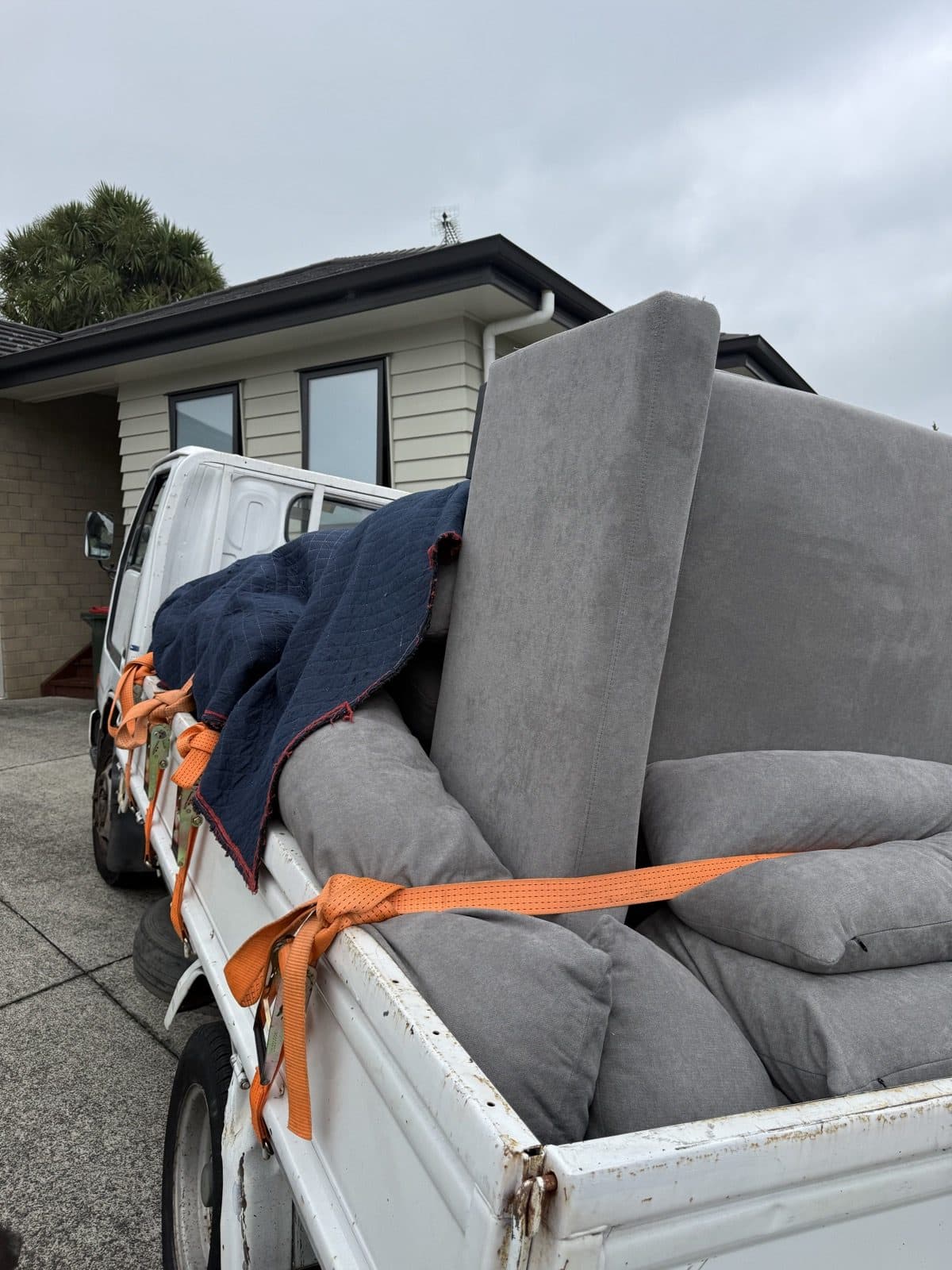 Sofa wrapped and strapped in for transport